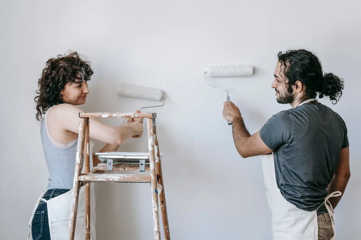 People painting a wall together — painting help in Tallahassee